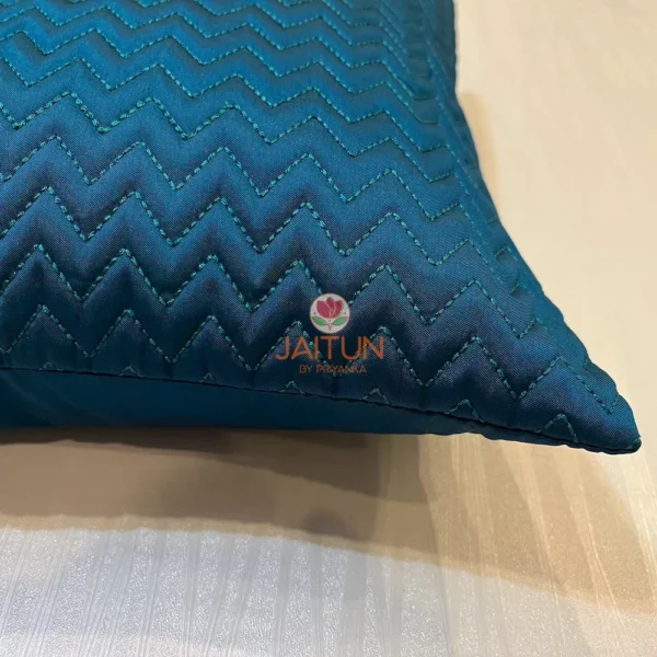 Close-up view of Azure Comfort Chevron Cushion in deep blue with zigzag quilted pattern