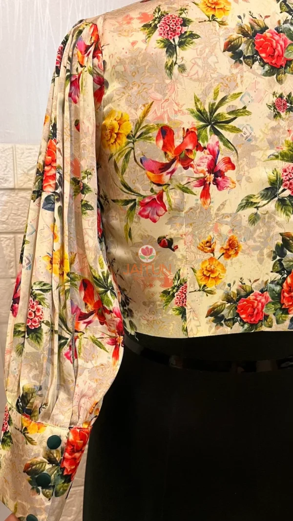 Back sleeve view of Blossom Elegance Floral Blouse featuring colorful floral motifs and pleated design
