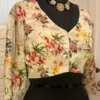 Side angled view of Blossom Elegance Floral Blouse showcasing detailed flower pattern and stylish sleeves