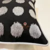 Close-up of Eclipse Polka Dot Cushion showing fine embroidery and luxury fabric finish