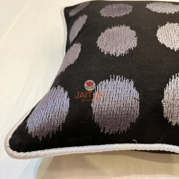 Thread detail view of Eclipse Polka Dot Cushion with shimmering silver dots on black