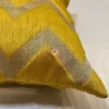 Close-up of cushion corner, showcasing the yellow chevron design and high-quality stitch
