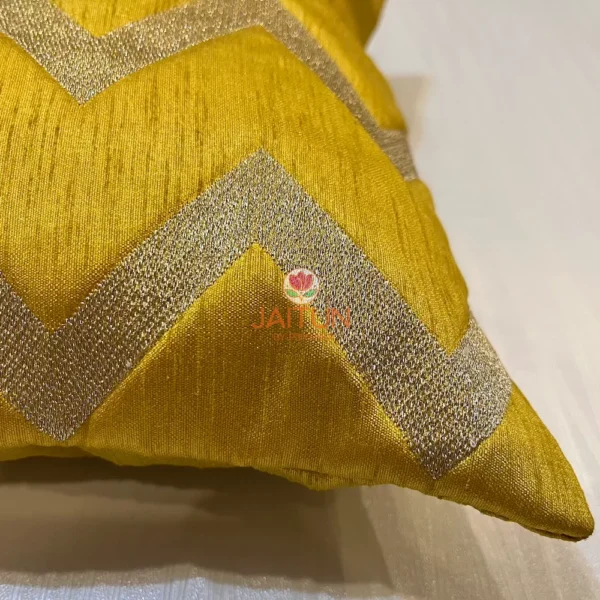 Close-up of cushion corner, showcasing the yellow chevron design and high-quality stitch