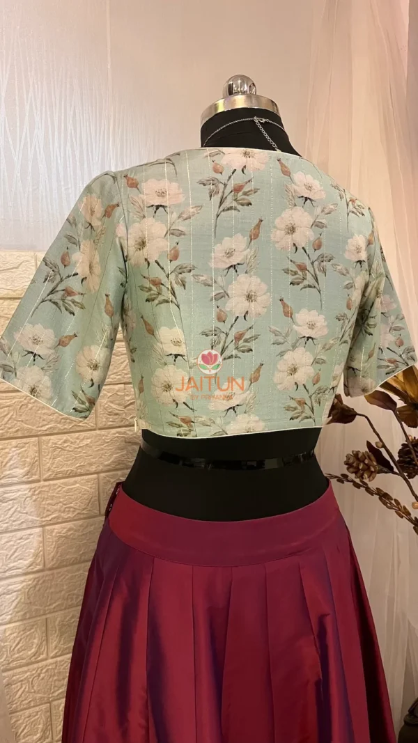 Back view of Elegant Blossom Embroidered Crop Top Blouse showing pastel blue floral pattern and short sleeves