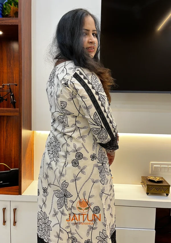 Back view of Elegant Floral Embroidered Kurta & Pant Suit Set featuring all-over black floral embroidery and lace trim