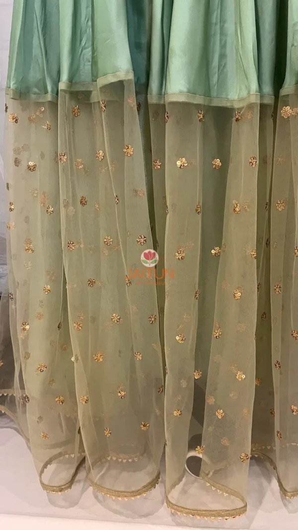 Embroidered tulle hem with gold accents on Enchanted Meadow Lehenga Skirt