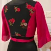 Back view of Floral Fantasy Ruffle Sleeve Crop Blouse featuring all-over red floral embroidery and fitted waist