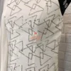 Detailed close-up of signature silver geometric pattern on Geometric Elegance Straight Dress, crafted from premium white Chinnon crepe fabric.