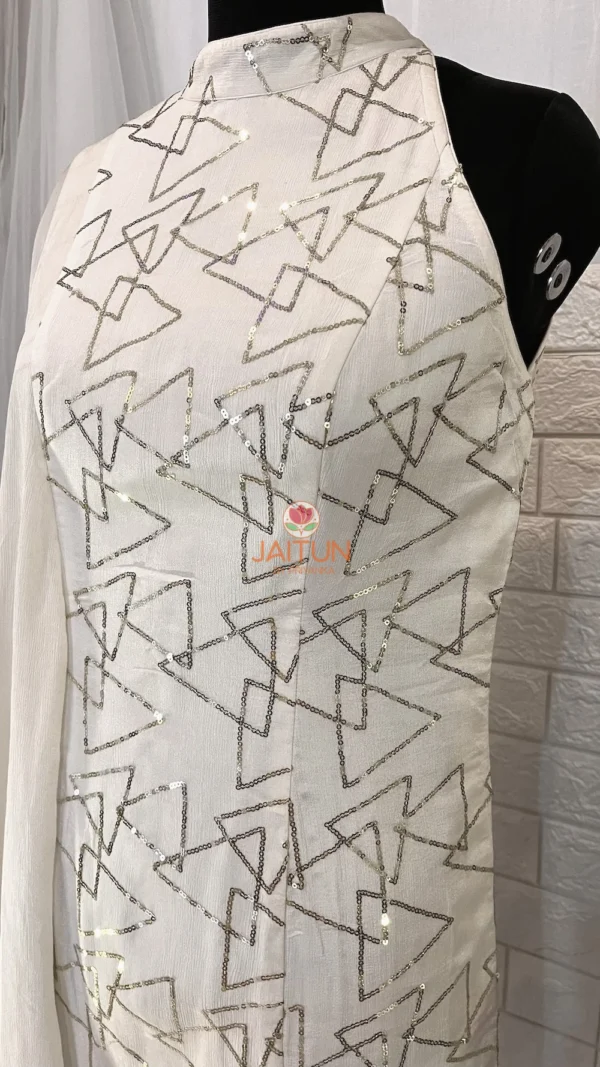 Detailed close-up of signature silver geometric pattern on Geometric Elegance Straight Dress, crafted from premium white Chinnon crepe fabric.