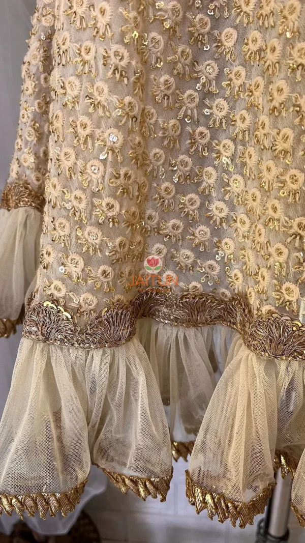 Hemline detail of Golden Grace Embellished A-Line Kurta showing intricate gold embroidery, layered frills, and premium craftsmanship for festive Kurti & Dress ensembles.