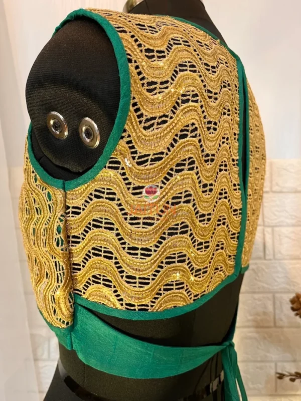 Detailed golden embroidery on teal green silk blouse with luxe threadwork and sequins