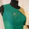 Side angle of teal green silk blouse with unique golden
