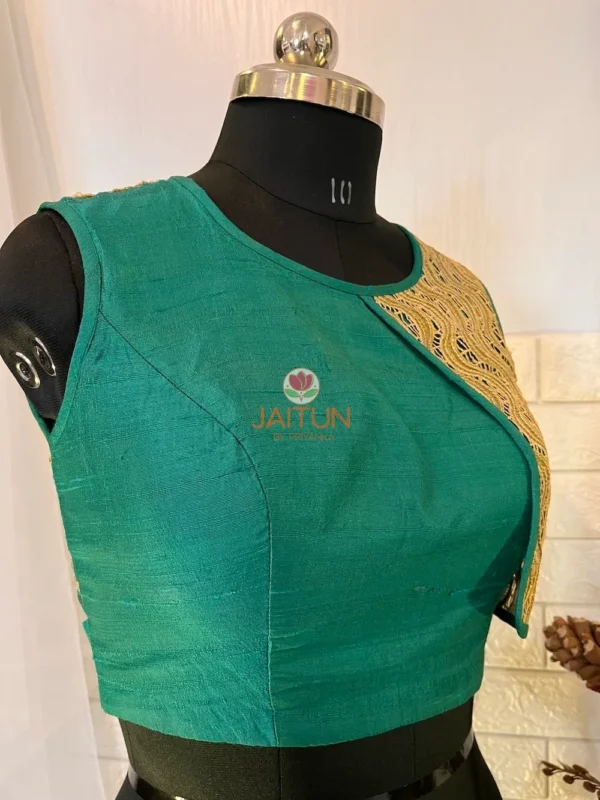 Side angle of teal green silk blouse with unique golden