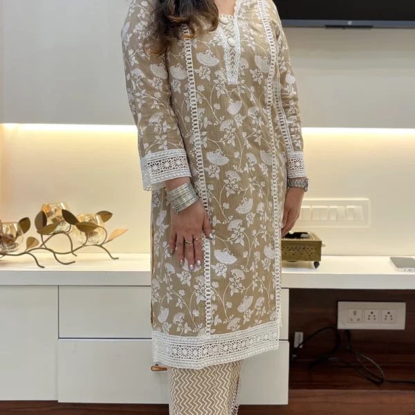 Close-up of sleeve on beige floral embroidered kurta suit with pant, showing detailed lace and floral embroidery