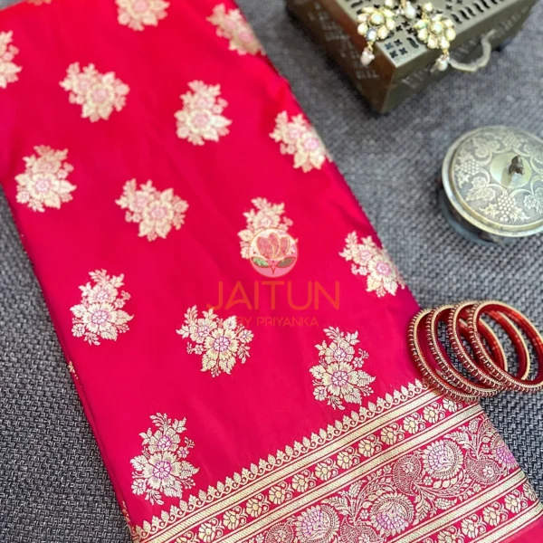 Crimson Bloom Banarasi Silk Saree flatlay with gold floral motifs and intricate zari border, paired with red bangles and traditional jewelry