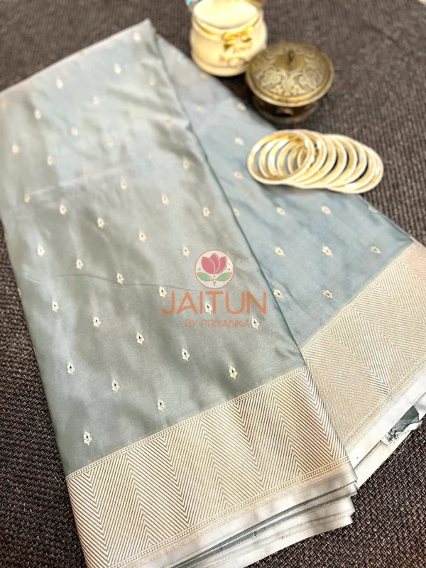 Elegant Grey Banarasi Silk Saree displayed with matching gold bangles and vintage box, showcasing refined zari work and soft sheen