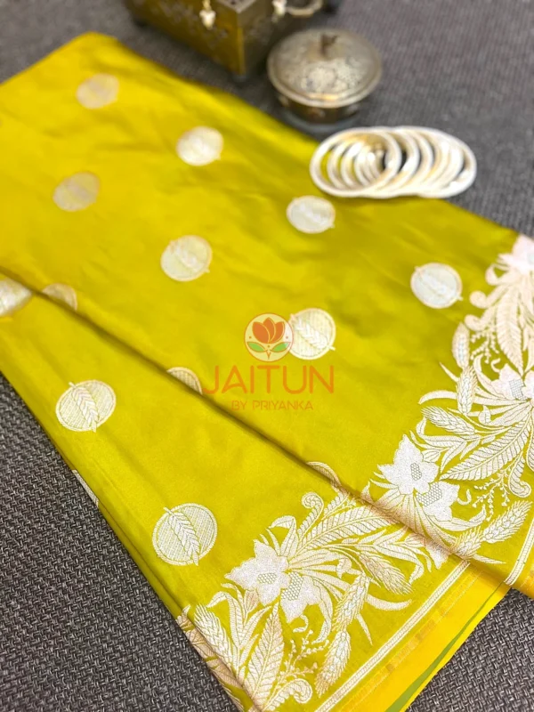 Detailed view of Lime Green Banarasi Silk Saree featuring intricate silver zari woven border and classic round motifs