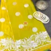 Lime Green Banarasi Silk Saree flatlay with silver zari floral border, circular motifs, and white bangles for traditional styling