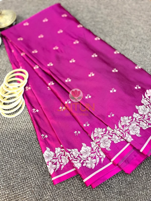 Detailed view of Magenta Grace Banarasi Silk Saree showing silver zari floral motifs and classic border design