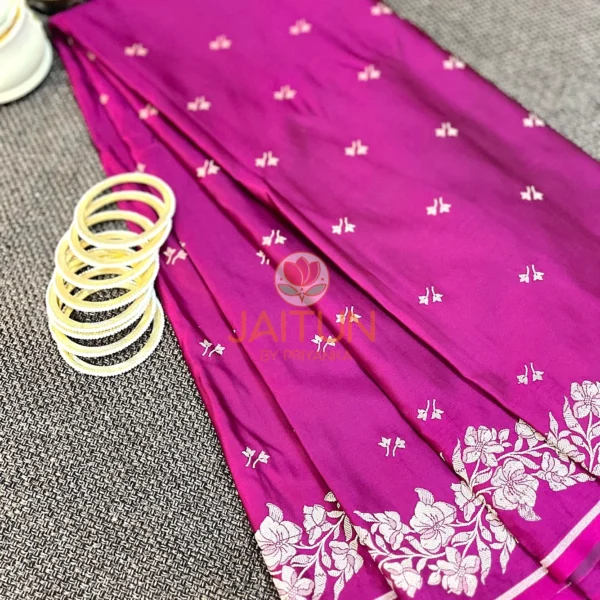 Magenta Grace Banarasi Silk Saree styled with white bangles and brass decor, highlighting ornate border and elegant craftsmanship