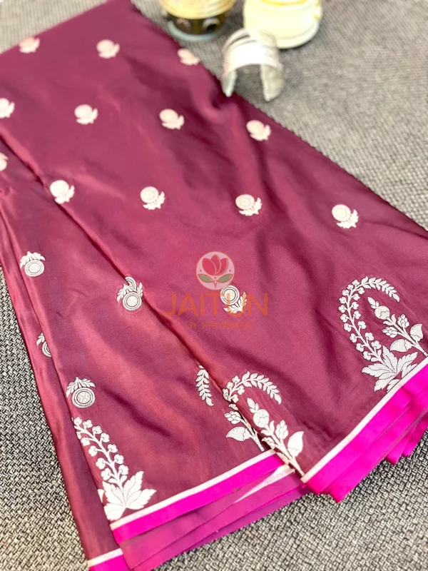Mulberry Grace Silk Saree displaying all-over white floral motifs and elegant silk texture with intricate weaving