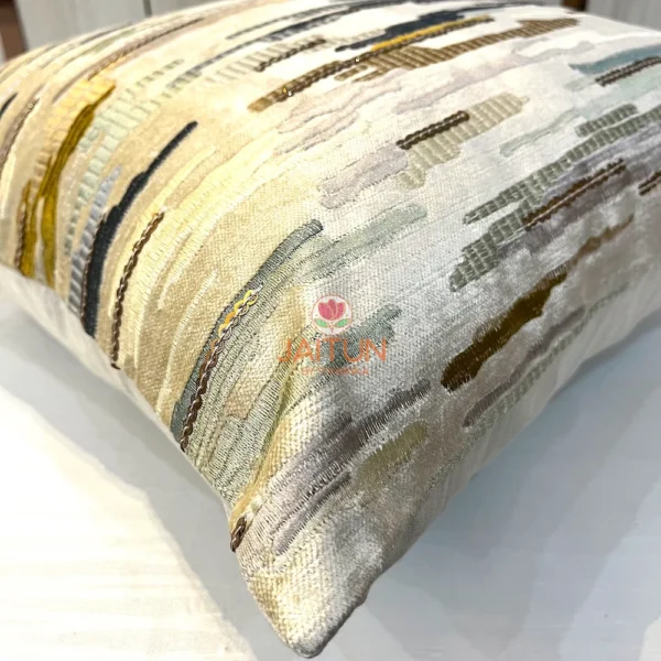 Corner detail of abstract brushstroke embroidered cushion cover in suede velvet