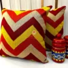 Set of Fiery Chevron Handwoven Cushion Covers Styled on Sofa - Vibrant Red and Yellow Chevron Pattern