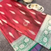 Gulnaar Maroon Silk Saree flatlay featuring traditional gold zari motifs and floral border paired with antique jewelry and bangles