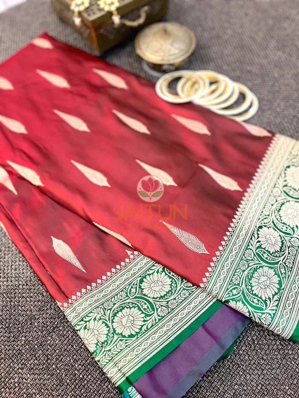 Gulnaar Maroon Silk Saree flatlay featuring traditional gold zari motifs and floral border paired with antique jewelry and bangles