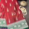 Gulnaar Maroon Silk Saree styled with white bangles and vintage jewellery, highlighting rich weave and elegant border design