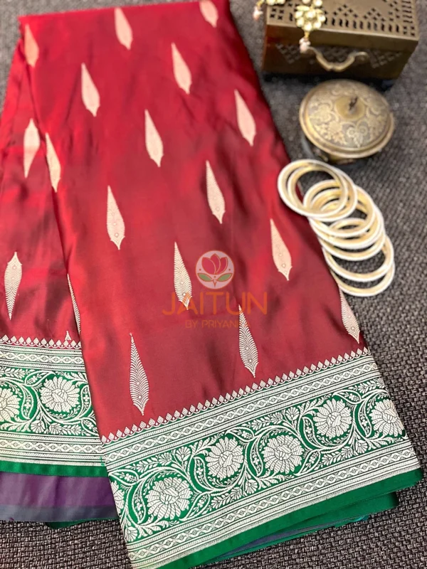Gulnaar Maroon Silk Saree styled with white bangles and vintage jewellery, highlighting rich weave and elegant border design