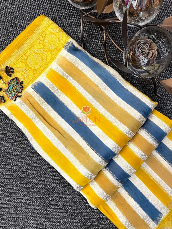 Mustard & Blue Striped Chiniya Silk Saree flatlay featuring vibrant vertical stripes and intricate floral zari border