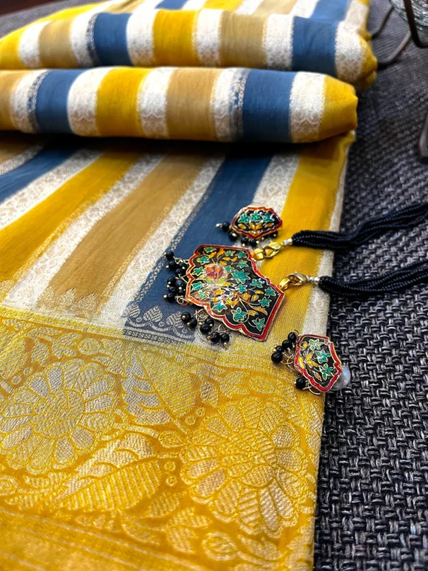 Mustard & Blue Striped Chiniya Silk Saree with statement jewelry placed on floral border and striped pattern