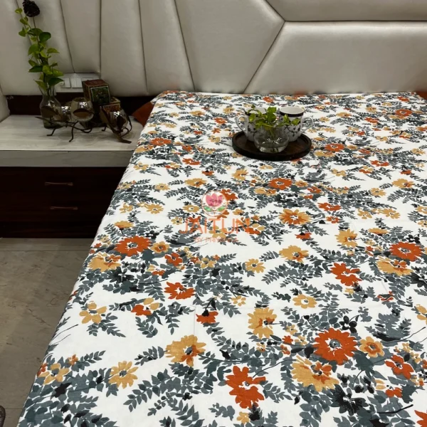 Angled view of Amber Floral Bloom bed sheet set showing all-over orange and yellow floral prints