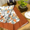 Corner display of Amber Floral Bloom bed sheet set with leafy floral pattern and rust brown border