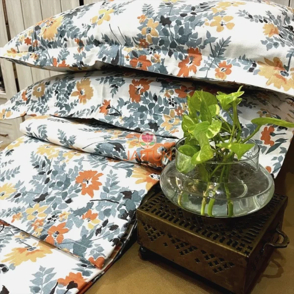 Decor display of Autumn Garden Bloom bed sheet set featuring all-over floral pattern with lush yellow, orange, and grey hues