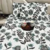 Azure Bloom Botanical Cotton Bedsheet Set spread on bed, showcasing all-over blue and grey botanical floral design.