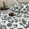 Azure Bloom Botanical Cotton Bedsheet Set closeup of pillow covers with blue and black floral and leaf motifs.