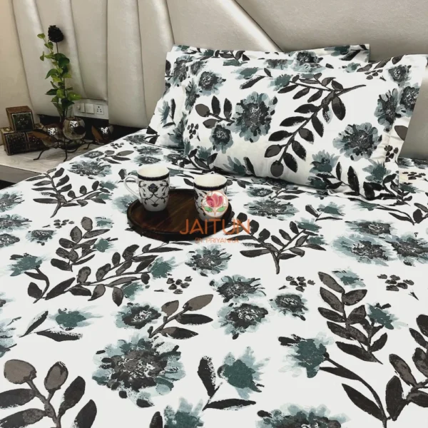 Azure Bloom Botanical Cotton Bedsheet Set closeup of pillow covers with blue and black floral and leaf motifs.