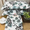 Stacked view of Azure Bloom Botanical Cotton Bedsheet Set featuring blue and grey floral prints with matching pillow covers.