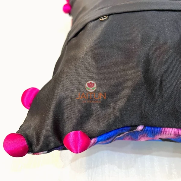 Back view of Birdsong Jungle embroidered cushion cover with button closure and pink pompoms