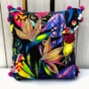Close-up embroidery details of Birdsong Jungle cushion cover featuring vibrant birds and flowers