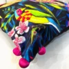 Detailed embroidery of parrot and floral motifs on Birdsong Jungle cushion cover