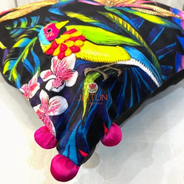 Detailed embroidery of parrot and floral motifs on Birdsong Jungle cushion cover