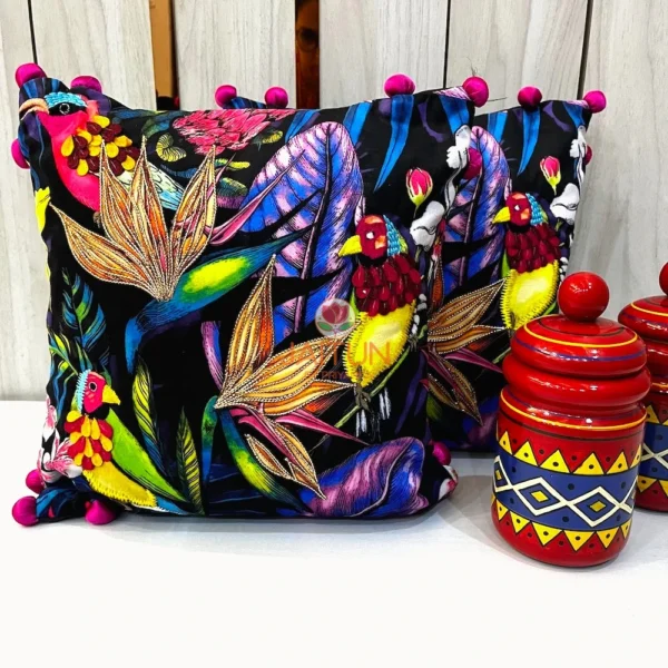 Embroidered cushion cover with tropical birds and jungle leaves on black background