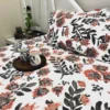 Decor view of Bold Blossom Bed Sheet Set on bed, featuring floral printed pillow covers and a cozy bedroom setup