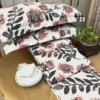 Arrangement of Bold Blossom Bed Sheet Set showcasing bold floral pattern, pillow covers, and decorative accents