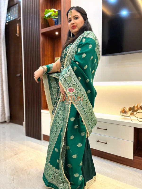Side pose in Emerald Enchant Wedding Collection Sharara Suit Set highlighting ornate dupatta with gold embroidery