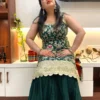 Seated pose in Emerald Enchant Wedding Collection Sharara Suit Set showcasing embroidered kurta and flared sharara pants
