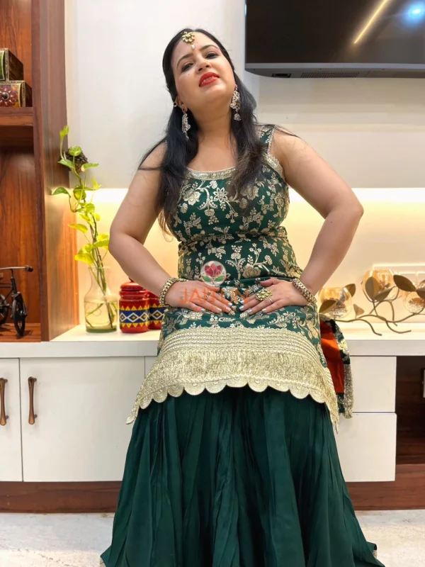 Seated pose in Emerald Enchant Wedding Collection Sharara Suit Set showcasing embroidered kurta and flared sharara pants